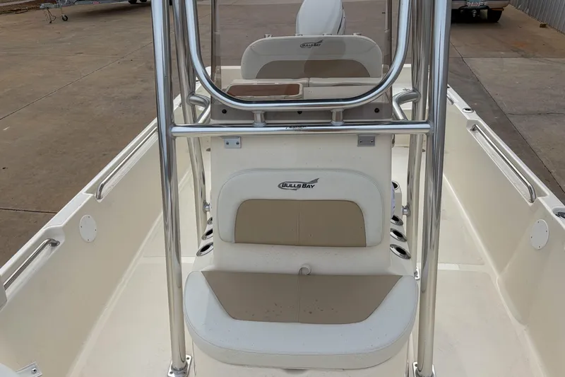 Slide: The Image of 2026 Bulls Bay 2400 boat interior with seating and console, showcasing sleek design. - 8