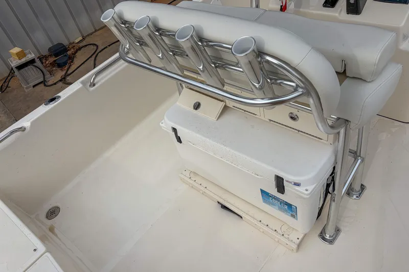 Slide: The Image of 2026 Bulls Bay 2400 boat interior with rod holders and cooler storage. - 9