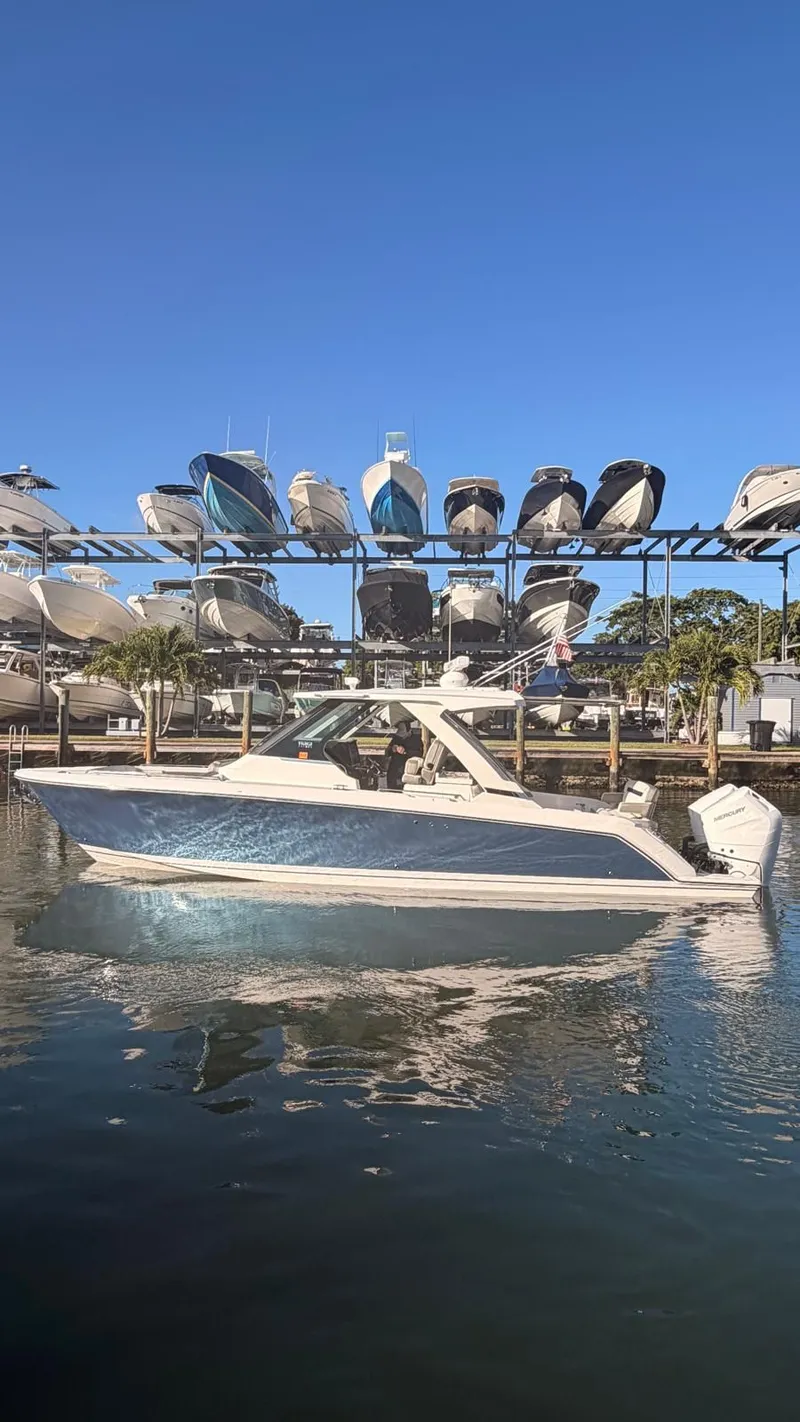 Slide: The Image of 2023 Tiara Sport 34 LS boat in water at a marina. - 17