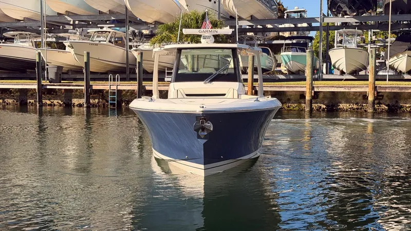 Slide: The Image of 2023 Tiara Sport 34 LS boat in water near dock. - 2