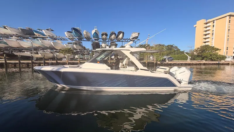 Slide: The Image of 2023 Tiara Sport 34 LS boat on water near marina. - 9