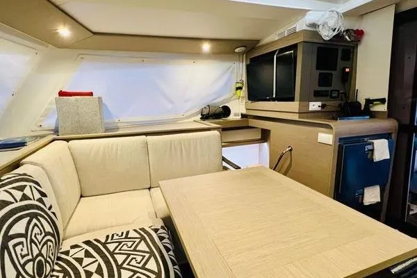 Slide: The Image of Interior of 2023 Fountaine Pajot Isla 40 catamaran with modern seating and entertainment area. - 14