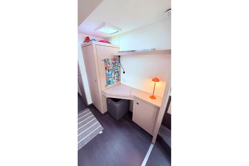 Slide: The Image of 2023 Fountaine Pajot Isla 40 interior with modern desk and vibrant decor. - 21