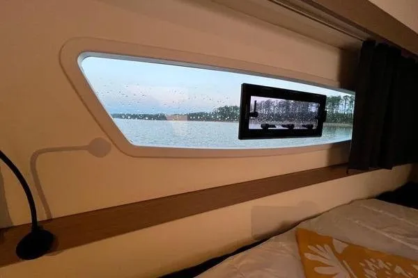 Slide: The Image of Cabin view from 2023 Fountaine Pajot Isla 40 catamaran, showcasing serene waterscape. - 25