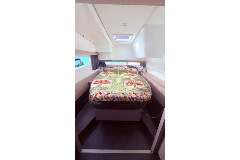 Slide: The Image of 2023 Fountaine Pajot Isla 40 cabin interior with colorful quilted bedspread. - 29
