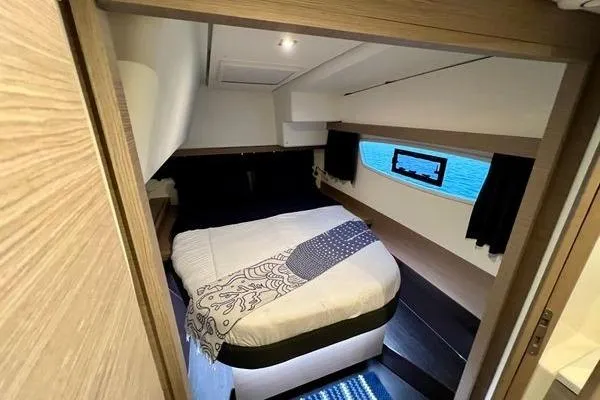 Slide: The Image of Luxurious cabin interior of 2023 Fountaine Pajot Isla 40 catamaran with cozy bed and window view. - 30