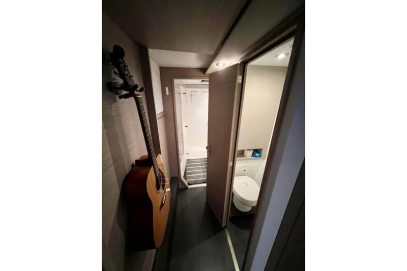 Slide: The Image of Interior of 2023 Fountaine Pajot Isla 40 yacht with guitar and bathroom. - 32