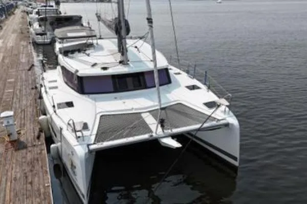 Slide: The Image of 2023 Fountaine Pajot Isla 40 catamaran docked at a marina. - 4