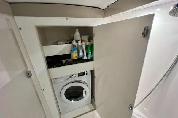 Slide: The Image of Laundry area with washing machine and storage in 2023 Fountaine Pajot Isla 40 yacht. - 42