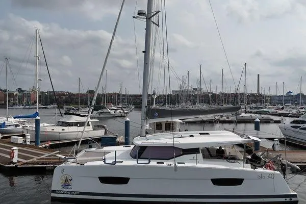 Slide: The Image of 2023 Fountaine Pajot Isla 40 catamaran docked in a marina with other boats. - 5