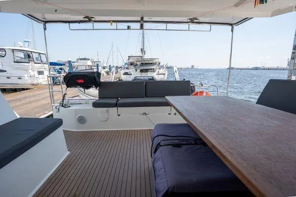 Slide: The Image of 2023 Fountaine Pajot Isla 40 catamaran with spacious deck and marina view. - 54