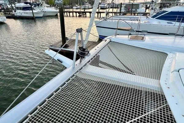 Slide: The Image of 2023 Fountaine Pajot Isla 40 catamaran docked at marina, featuring netted deck area. - 61