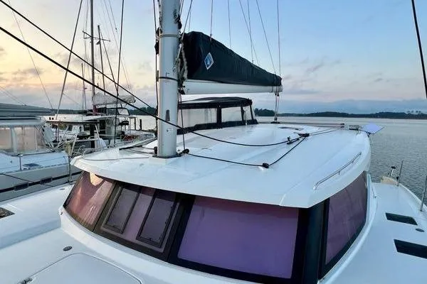 Slide: The Image of 2023 Fountaine Pajot Isla 40 catamaran docked at sunset, showcasing sleek design and modern features. - 62