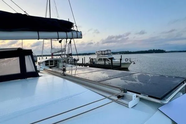 Slide: The Image of 2023 Fountaine Pajot Isla 40 catamaran docked at sunset with solar panels. - 64
