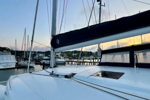 Slide: The Image of 2023 Fountaine Pajot Isla 40 catamaran docked at sunset, showcasing sleek design. - 65