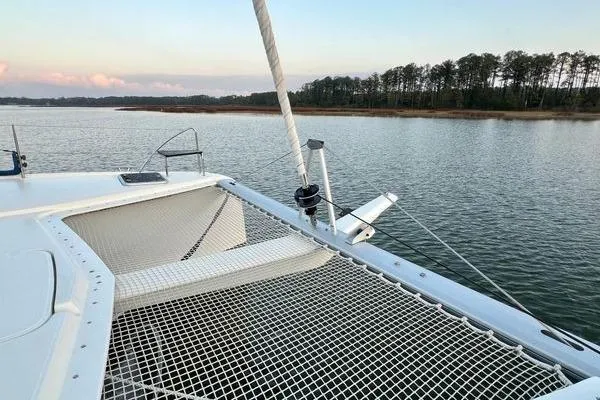 Slide: The Image of 2023 Fountaine Pajot Isla 40 catamaran on serene water with forested shoreline. - 66