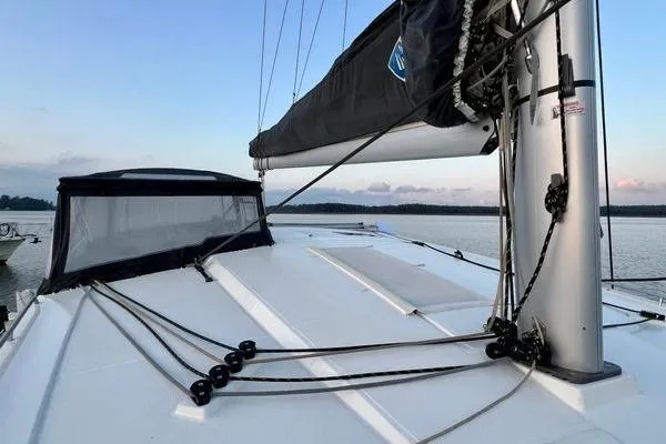 Slide: The Image of 2023 Fountaine Pajot Isla 40 catamaran deck with mast and rigging at sunset. - 69
