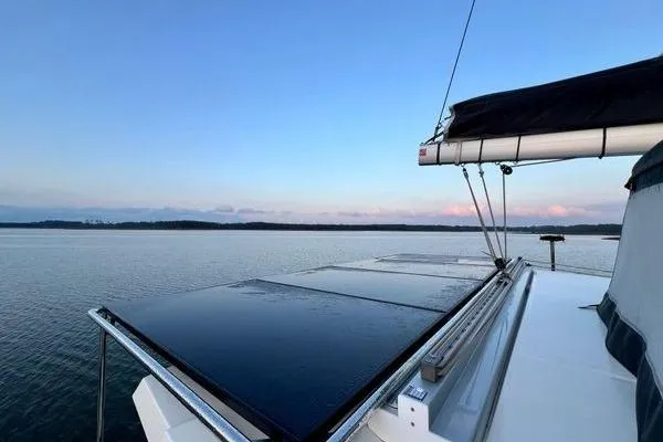 Slide: The Image of 2023 Fountaine Pajot Isla 40 catamaran sailing on calm waters at sunset. - 72