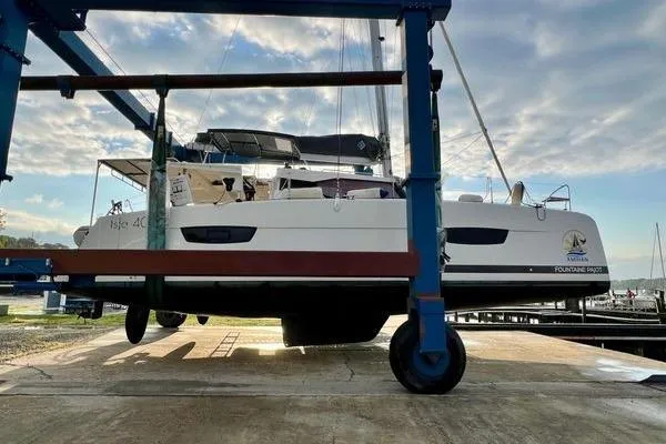 Slide: The Image of 2023 Fountaine Pajot Isla 40 catamaran on a lift, showcasing sleek design and modern features. - 79