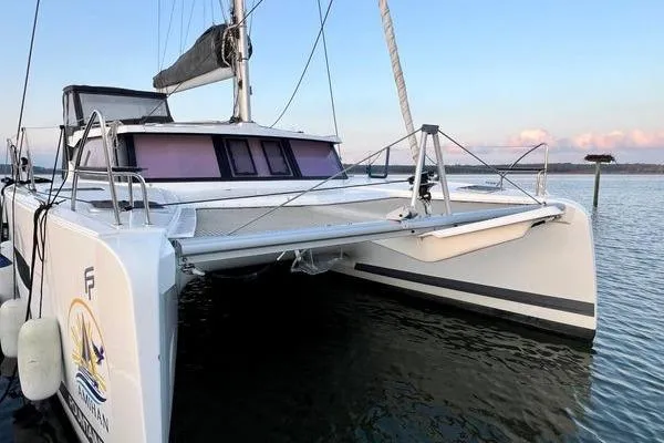 Slide: The Image of 2023 Fountaine Pajot Isla 40 catamaran on calm water at sunset. - 8