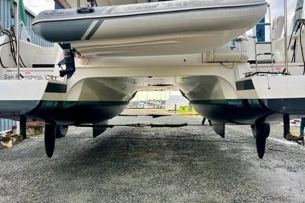 Slide: The Image of 2023 Fountaine Pajot Isla 40 catamaran, rear view, on land with tender boat. - 82
