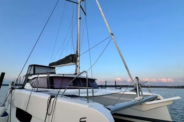 Slide: The Image of 2023 Fountaine Pajot Isla 40 catamaran on calm water at sunset. - 9