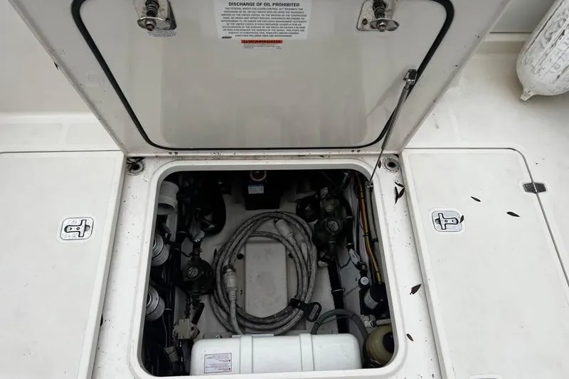 Slide: The Image of Twin Yamaha outboard motors on a 2014 Pursuit OS 345 Offshore boat docked by water. - 14