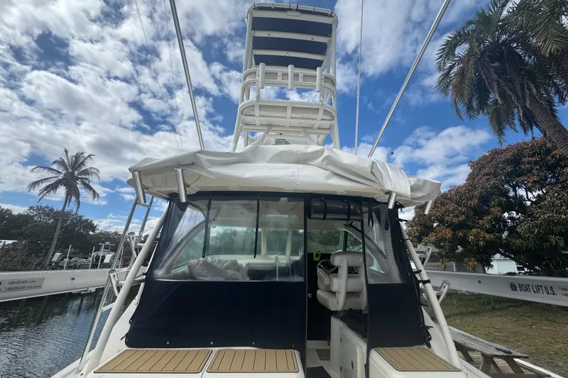 Slide: The Image of 2014 Pursuit OS 345 Offshore boat docked under a partly cloudy sky. - 20