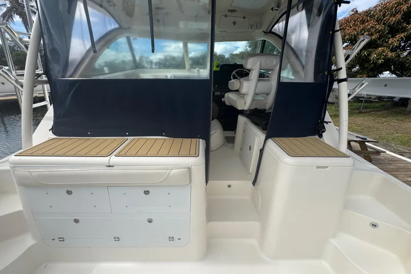Slide: The Image of 2014 Pursuit OS 345 Offshore boat interior with seating and storage compartments. - 22