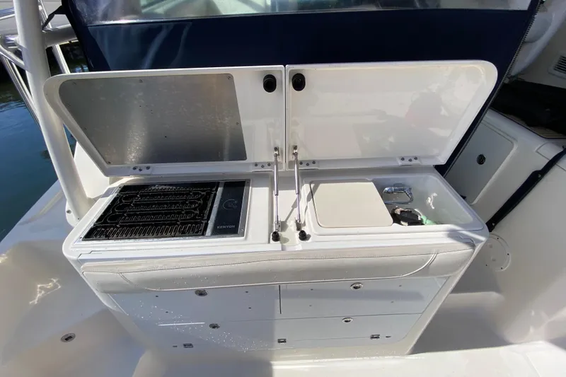 Slide: The Image of Outdoor kitchen on 2014 Pursuit OS 345 Offshore boat with grill and sink. - 23