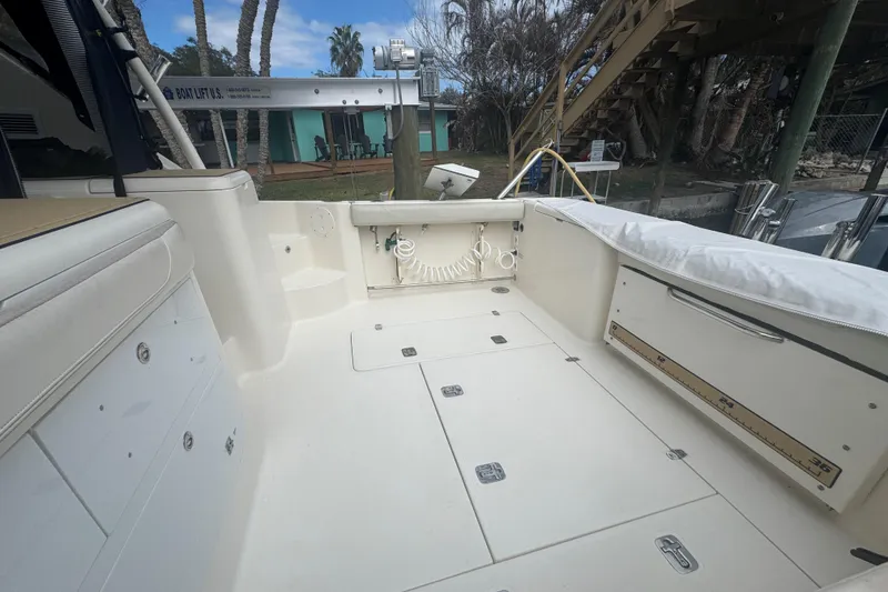 Slide: The Image of 2014 Pursuit OS 345 Offshore boat deck with storage compartments and seating. - 24