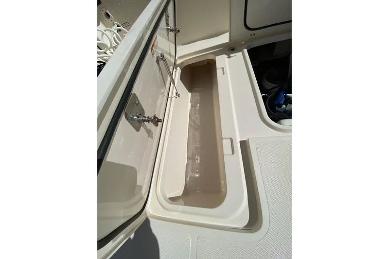 Slide: The Image of Open storage compartment on a 2014 Pursuit OS 345 Offshore boat. - 26