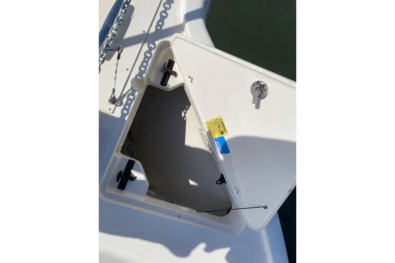 Slide: The Image of Open storage compartment on 2014 Pursuit OS 345 Offshore boat deck. - 35