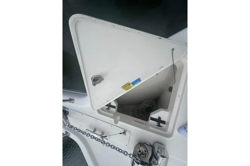 Slide: The Image of Open anchor locker on 2014 Pursuit OS 345 Offshore boat, showing chain and rope storage. - 36