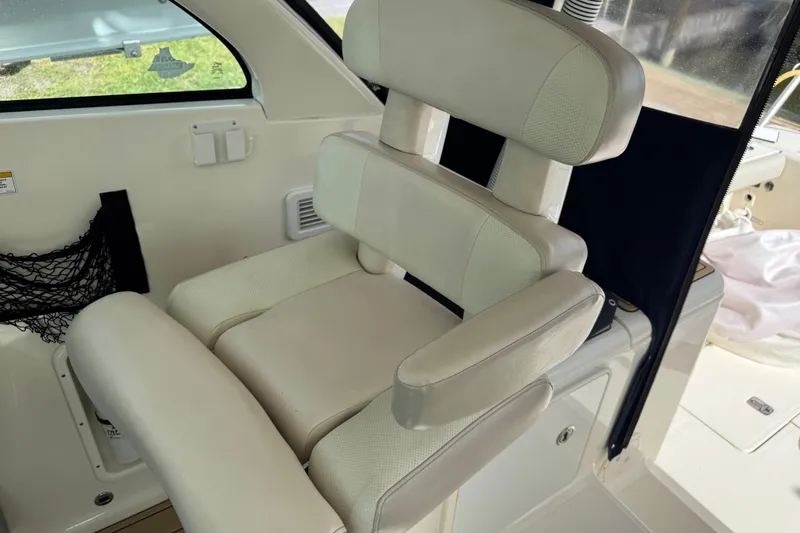 Slide: The Image of 2014 Pursuit OS 345 Offshore boat interior with cushioned seating. - 53