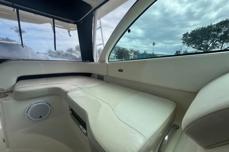 Slide: The Image of Interior of 2014 Pursuit OS 345 Offshore boat with white seating and window view. - 55