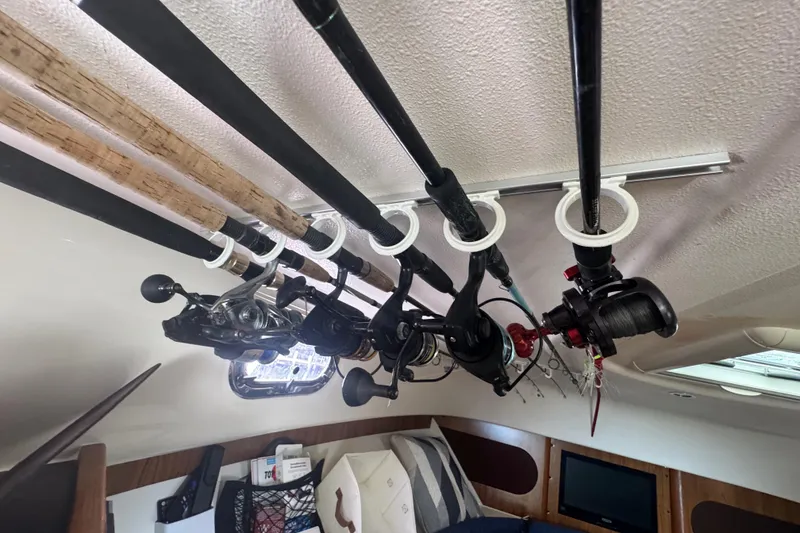 Slide: The Image of Fishing rods stored in cabin of 2014 Pursuit OS 345 Offshore boat. - 64