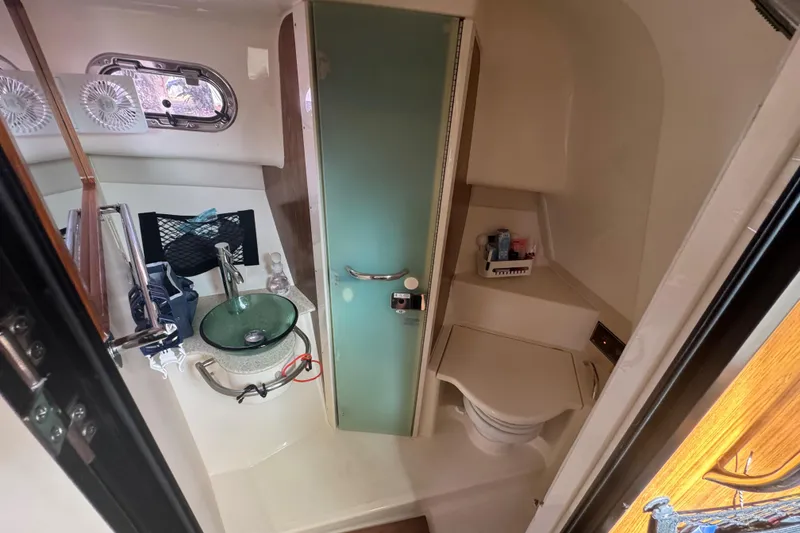 Slide: The Image of 2014 Pursuit OS 345 Offshore boat bathroom with sink, toilet, and storage. - 67