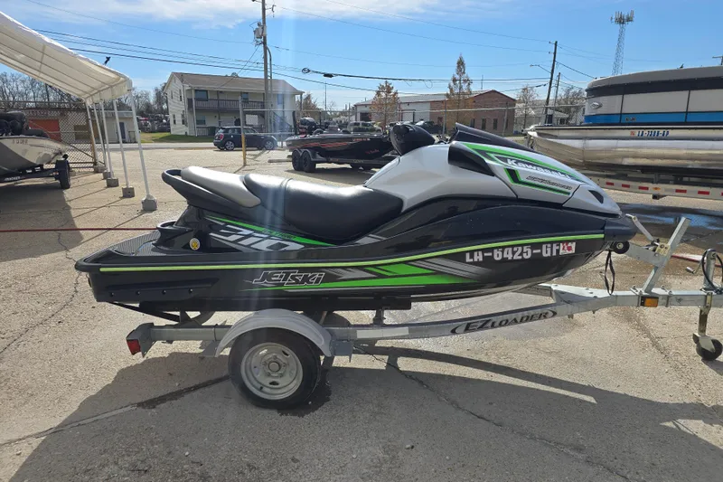 Slide: The Image of 2016 Kawasaki Jetski Ultra 310X on trailer, parked outdoors in a lot. - 2