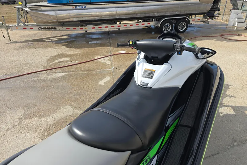 Slide: The Image of 2016 Kawasaki Jetski Ultra 310X parked on concrete near a trailer. - 4