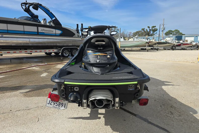 Slide: The Image of 2016 Kawasaki Jetski Ultra 310X parked on concrete near boats and trailers. - 7