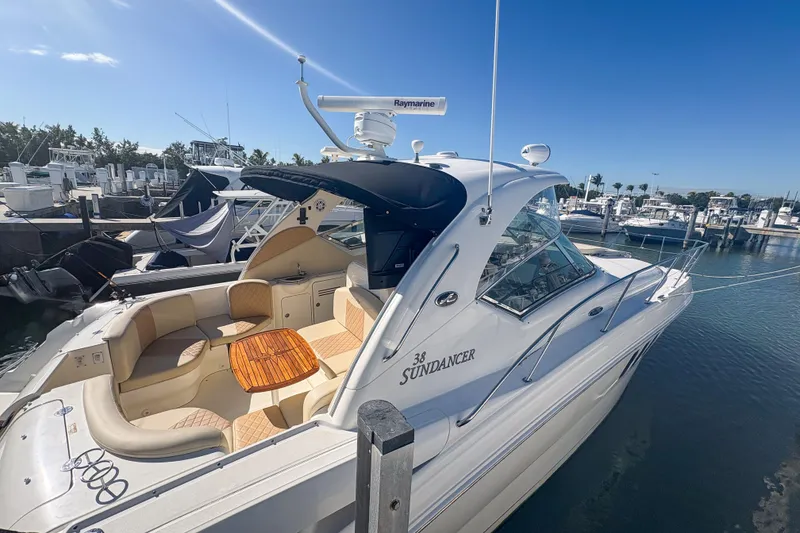 Slide: The Image of 2008 Sea Ray 380 Sundancer yacht docked at marina under clear blue sky. - 11