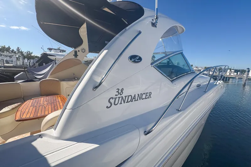 Slide: The Image of 2008 Sea Ray 380 Sundancer yacht docked, featuring sleek design and spacious seating area. - 12