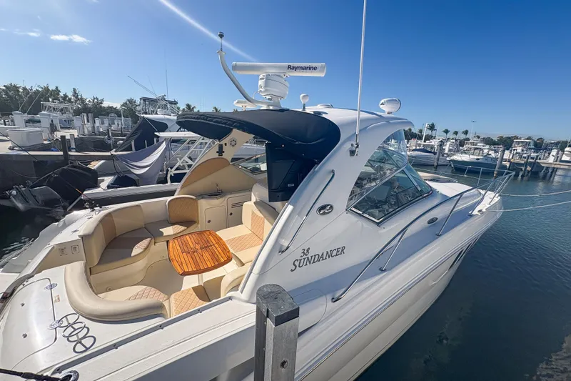 Slide: The Image of 2008 Sea Ray 380 Sundancer yacht docked at marina under clear blue sky. - 14