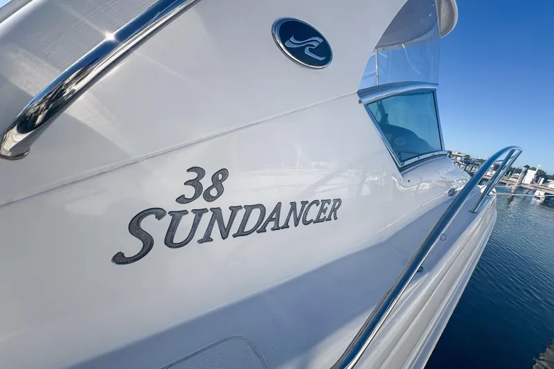 Slide: The Image of 2008 Sea Ray 380 Sundancer yacht docked, showcasing sleek design and branding. - 18