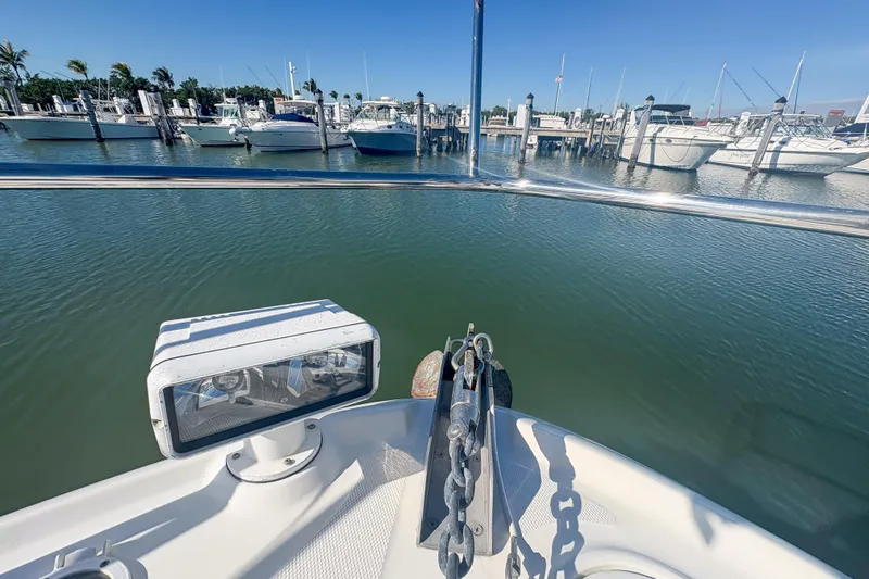Slide: The Image of Bow view of 2008 Sea Ray 380 Sundancer in a marina, surrounded by boats. - 28