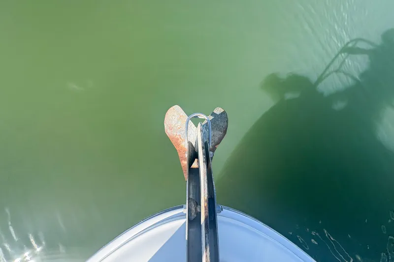 Slide: The Image of Bow view of 2008 Sea Ray 380 Sundancer with anchor over green water. - 30