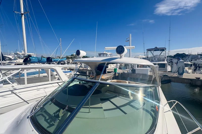 Slide: The Image of 2008 Sea Ray 380 Sundancer yacht docked at marina under clear blue sky. - 33
