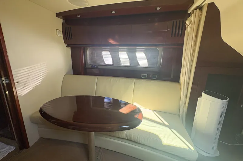 Slide: The Image of Interior of 2008 Sea Ray 380 Sundancer with elegant seating and wooden table. - 47
