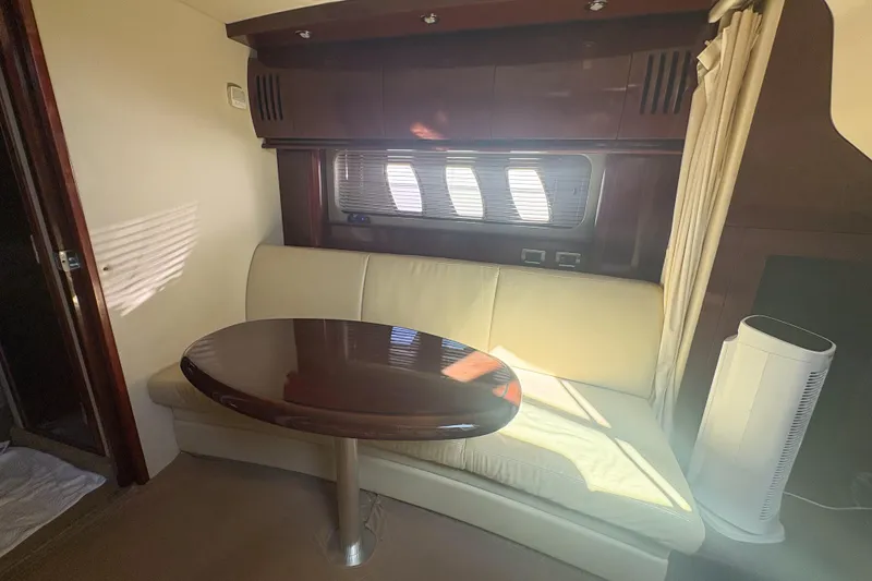 Slide: The Image of Interior of 2008 Sea Ray 380 Sundancer with elegant seating and wooden table. - 48